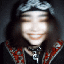 a blurry picture of a woman wearing a bandana and necklace