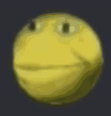 a blurry picture of a yellow smiley face with eyes on a dark background .