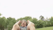 a man wearing a headband is doing sit ups in the park