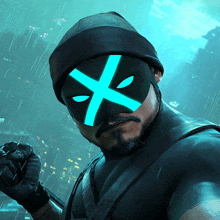 a man is wearing a mask with a blue x on it