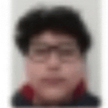 a blurry picture of a man 's face with glasses and a red collar .