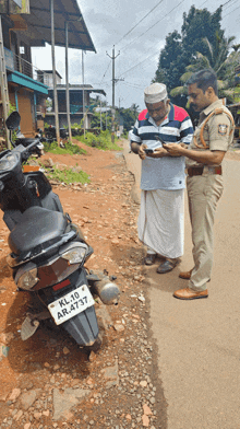 a man standing next to a scooter with a license plate that says kl 10