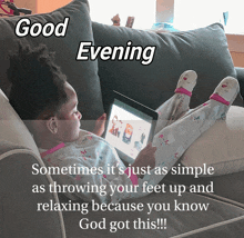 a little girl is laying on a couch using a tablet and a good evening message