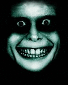 a close up of a person 's face with glowing eyes and a smile .