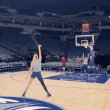 a basketball game is being played in an empty stadium with a scoreboard that says at & t on it