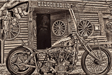 a black and white photo of a motorcycle parked in front of a wooden saloon .