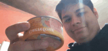 a man is holding a can of tuna that says ' costigo ' on it