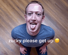 a man sticking out his tongue with the words zucky please get up written below him