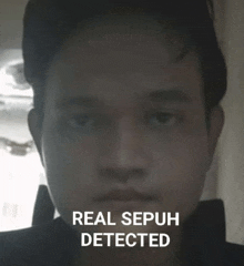 a man 's face is shown in a black and white photo with the words `` real sepuh detected '' .