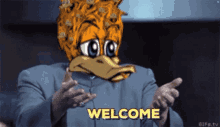 a man in a suit with a cartoon duck on his head is saying welcome