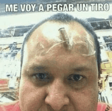 a man with a bullet in his forehead and the words me voy a pegar un tiro