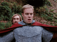 a man with a red cape on his head looks surprised