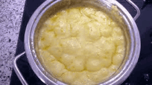 a pot of food is being cooked on a stove top .