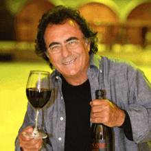 a man holding a bottle and a glass of wine with a label that says platonic