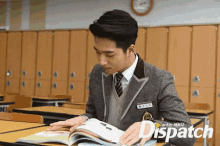 a man in a suit and tie is reading a book in a classroom with dispatch written in the corner