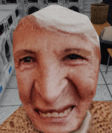 a close up of a person 's face in a laundromat with a basket in the background