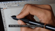 a hand is holding a pen in front of a computer screen that says photoshop file edit image layer select filter analysis 3d view window help