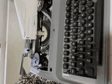 a typewriter with a piece of paper coming out of it and the word automatic on the keyboard