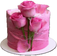 a pink cake with pink roses on top of it .