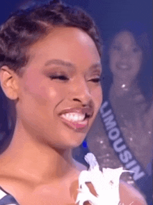 a woman wearing a sash that says limousine on it is smiling