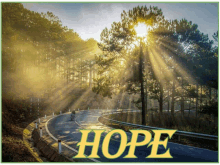 a person riding a bike down a road with the word hope above them