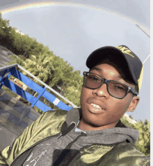 a young man wearing a nike hat and sunglasses