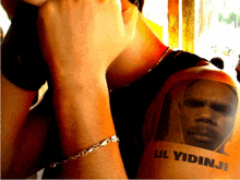 a man with a tattoo on his arm that says lil yidinji