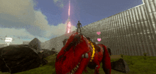 a man stands on top of a red dinosaur in front of a fence