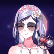 a girl with sunglasses and a flower in her hair is holding a microphone