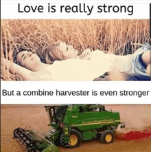 a man and a woman are laying in a field with a combine harvester in the background .