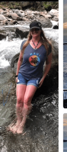 a woman in a maui shirt is standing in the water