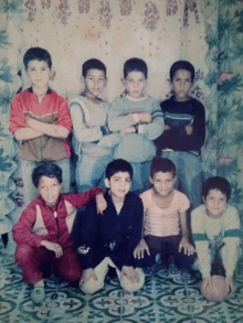 a group of young boys posing for a photo with their arms crossed