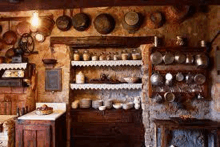 a kitchen with a lot of pots and pans on the wall .