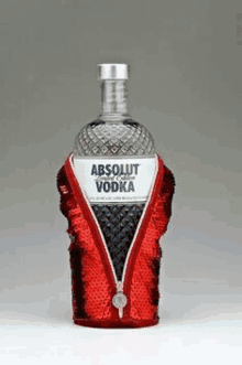 a bottle of absolut vodka has a red sequined jacket on it