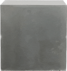 a gray cube is sitting on a white background .