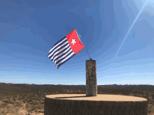 a blue and white flag with a red star on the top