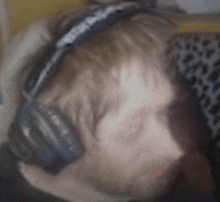 a blurry picture of a man wearing headphones and a leopard print shirt