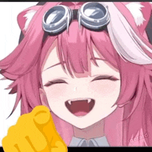 a girl with pink hair and goggles is laughing and pointing at the camera with her finger .