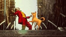 a man dressed as the joker is dancing with a dog on the stairs