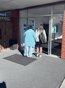 a woman with a backpack that says o'neill walks with another woman