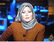 a woman wearing a striped scarf is on a tv screen