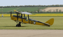 a small yellow plane with the number 590 on it