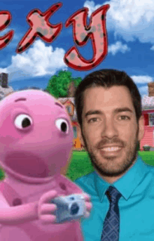 a man in a blue shirt and tie holds a camera next to a pink cartoon character with the word oxy on it