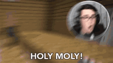 a blurry picture of a man with glasses and the words holy moly .