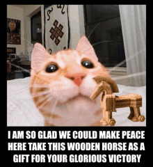 a picture of a cat with a wooden horse in its mouth