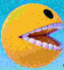 a pac man smiley face with its mouth open and teeth .