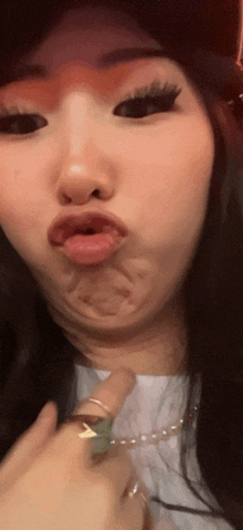 a close up of a woman making a funny face with her tongue out