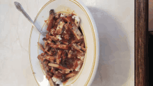 a bowl of food on a table with a fork