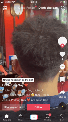 a phone screen shows a video of a man getting his hair cut by a barber named le phuong quy