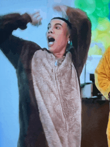 a man in a monkey costume is dancing with his mouth open